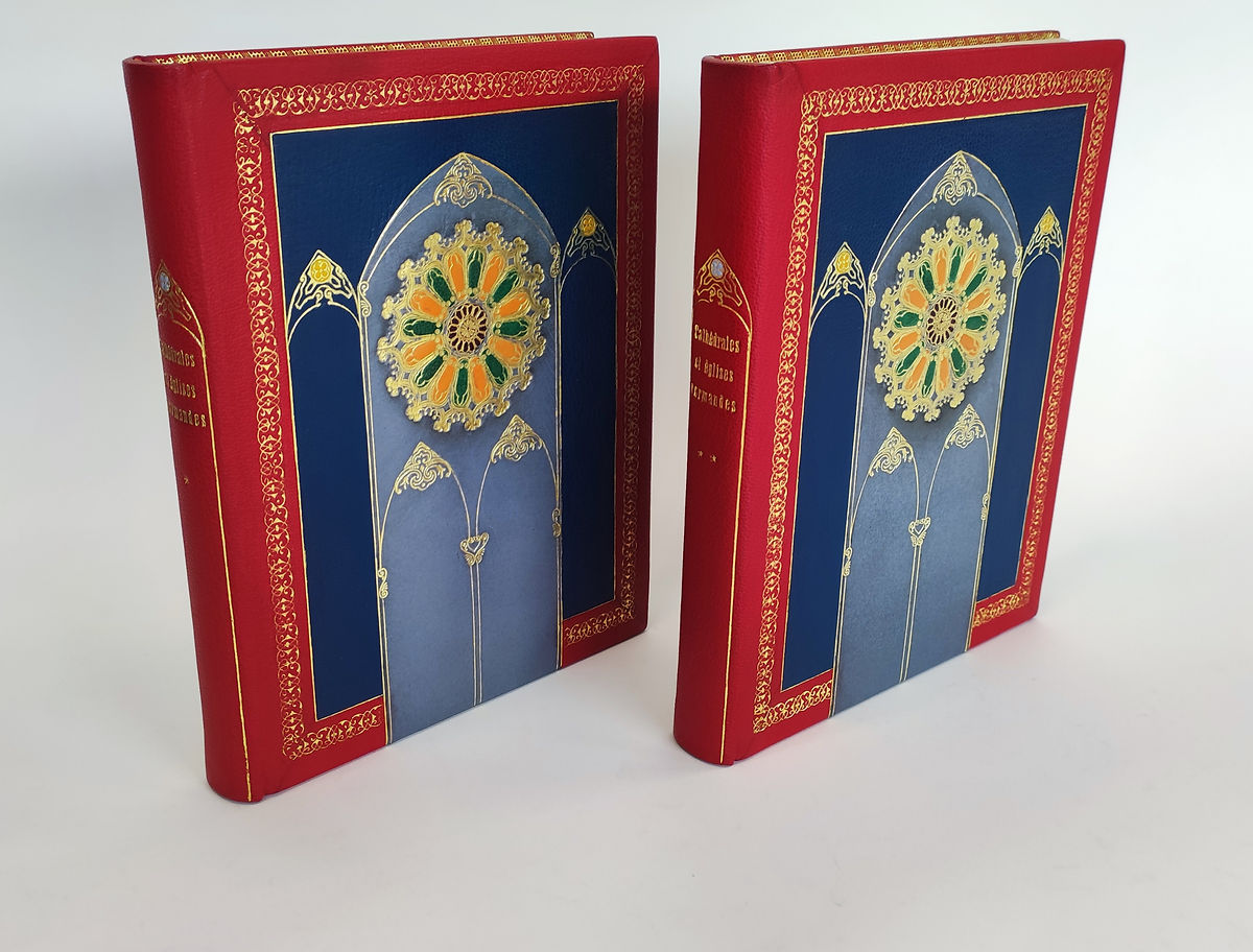 collection de deux livres sur les églises normandes reliée en plein cuir avec un décor de cathédrale en mosaïque de cuir (rosace)